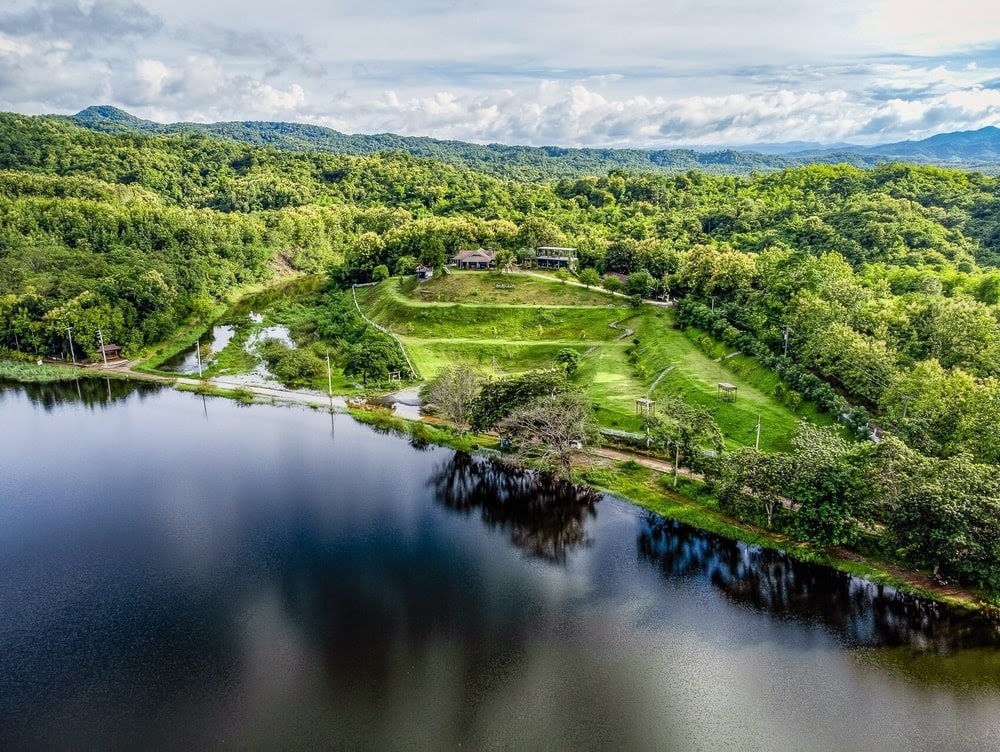 The Best Feng Shui House For Sale, surrounded by reservoir and mountains.